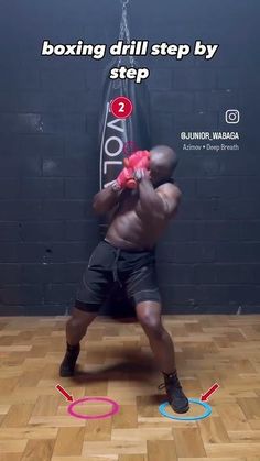 the man is practicing his moves in the gym with an exercise ring around his neck