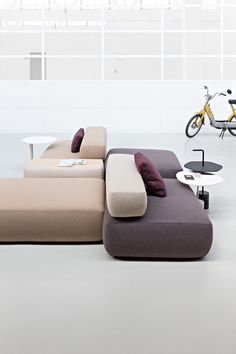 a living room filled with furniture and a bike parked on the wall next to it