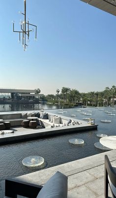 an outdoor seating area next to a body of water