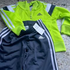 Neon Green Yellow Adidas Track Suit 12 Months Nwt But See Small Pen Marks Otherwise Mint Condition And Adorable And Sheek Casual Yellow Sets With Long Sleeves, Casual Yellow Long Sleeve Sets, Adidas Sports Set With Long Sleeve, Adidas Long Sleeve Playwear Sets, Adidas Fitted Playwear Sets, Adidas Fitted Sets For Playwear, Adidas Sporty Playwear Sets, Sporty Long Sleeve Playtime Sets, Casual Adidas Sets For Spring