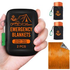 an emergency blanket is being held up by someone's hand and two other items are in the background