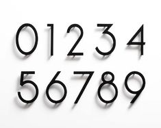 the numbers are arranged in black on a white background, with one number being cut out