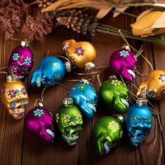 colorful skull ornaments are arranged on a wooden table