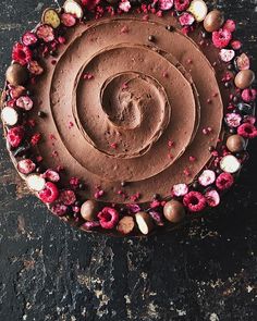 a chocolate cake with pink flowers on top