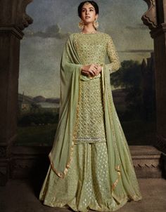 ⚡️✨ With its meticulous craftsmanship and attention to detail, this lehenga suit is a true masterpiece of elegance. The lehenga style adds a traditional touch, while the contemporary design elements give it a modern twist.🌟✨ https://www.arabicattire.com/products/army-green-net-lehenga-suit-st8804-8804 #ArmyGreenLehengaSuit #NetFabricEnsemble #LehengaStyle #ArabicAttire #EnchantingElegance #SophisticationAndCharm #LuxuriousAppeal #TraditionalYetModern Green Anarkali Suits, Indo Western Lehenga, Western Lehenga, Green Anarkali, Readymade Salwar Kameez, Lehenga Suit, Long Gown Dress, Net Lehenga, Sharara Suit