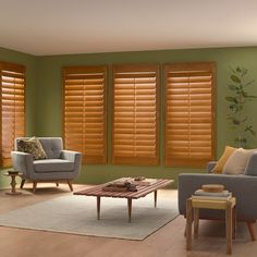 a living room filled with furniture and windows covered in wooden blinds on top of them