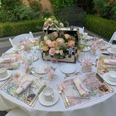 a table set with place settings and flowers