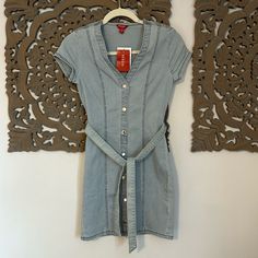 Guess Denim Dress. Brand New. Never Worn. Short Sleeve With Tie Around Waist. Size Xs. Excellent Condition. Fitted Medium Wash Denim V-neck Top, Fitted Short Sleeve Denim Top For Spring, Fitted Short Sleeve Denim Top For Day Out, Light Wash Fitted Short Sleeve Dress, Fitted V-neck Denim Top In Medium Wash, Fitted Denim Blue V-neck Top, Fitted V-neck Medium Wash Denim Top, Light Wash Fitted Short Sleeve Denim Dress, Fitted Short Sleeve Denim Dress In Light Wash