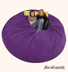 two women sitting on a bean bag chair