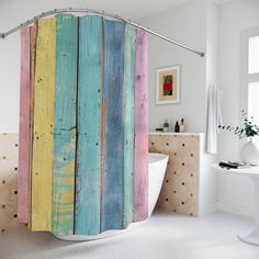 a colorful shower curtain in a bathroom with white walls and wood planks on the wall