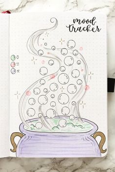 a notebook with an image of a pot full of bubbles on it and the words mood tracker