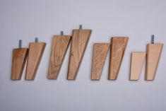 five pieces of wood hang on the wall