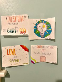 three pieces of paper taped to the side of a wall with writing on it and two magnets attached to them