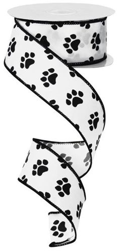 a roll of black and white dog paw print grosch ribbon on a white background