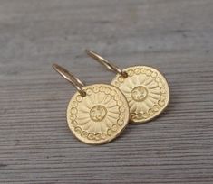 "Beautiful handmade gold Mandala flower discs swing from gold filled ear wires. ❉ F A C T S total length from top of ear wire: 1\" /2.5 cm disc: 0.5\"/ 1.3 cm diameter You will receive this Mandala Jewelry in a gift box, with an inspiring card, ready to be given as an empowering gift. Your earrings may vary slightly from the ones in the picture. Each pair is handmade to order. Feel free to contact me for any custom request : http://www.etsy.com/convo_new.php?to_username=ravitschwartz This design Adjustable Gold Round Flower Earrings, Gold Dangle Flower Earrings With French Hook, Gold Round Flower Earrings With Ear Wire, Gold Round Flower Earrings For Everyday, Handmade Gold Flower Earrings For Everyday, Dainty Gold Round Disc Earrings, Mandala Jewelry, Mandala Earrings, Gold Mandala