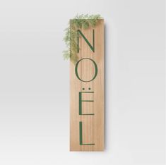 a wooden sign with the word noel on it