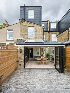 an open patio area in front of a brick building