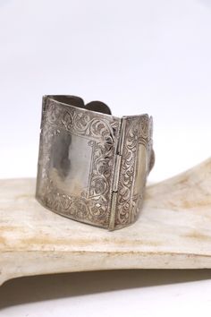 Beautiful vintage three panel silver bracelet. The panel are hand engraved on the surface.   large central panel size : 2 1/2 in x 2 1/4 in Length: 7.5 in roughly Weight: 75 grams Minor scratching on the surface .In overall good condition. Silver Etched Cuff Bracelet For Wedding, Antique Silver Engraved Cuff Bracelet, Victorian Style Silver Engraved Bangle, Victorian Silver Engraved Bangle, Engraved Antique Silver Cuff Bracelet, Victorian Style Engraved Silver Bangle, Silver Stamped Cuff Bracelet For Wedding, Antique Silver Etched Cuff Bangle, Vintage Engraved Cuff Bracelet For Ceremonial Occasions