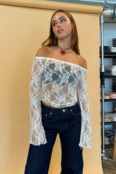 Also available in Black. Styled with the Avery Dark Denim Low Rise Jeans. Product Deets White lace off the shoulder long sleeve top 95% nylon, 5% spandex Floral lace fabric Elastic trim around top with scalloped edge detail Flare sleeve Full length top Size small measures 14” long Runs true to size Model Info Meghan is 5’6. Waist: 26" Bust: 34A Wearing size Small. Spring Stretch Long Sleeve Off-shoulder Top, Stretch Lace Off-shoulder Top, Fitted Lace Off-shoulder Top, Long Sleeve Stretch Tops With Lace Patchwork, Fitted Top With Lace Patchwork For Fall, Stretch Long Sleeve Top With Lace Patchwork, Long Sleeve Tops With Lace Patchwork And Stretch, Stretch Long Sleeve Tops With Lace Patchwork, Fitted Off-shoulder Lace Top For Party