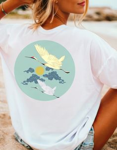 Zen Design Unique Tee, Back graphic of Japanese Birds, clouds and Moon, Meditative Harmony on your clothing for beach, pool, and yoga. Wear this beautiful Tshirt anytime to elevate your mood and style. For the conscious style wearing being of any gender and sophistication. Love wearing this peaceful design.... The unisex soft-style t-shirt puts a new spin on casual comfort. Made from very soft materials, this tee is 100% cotton for solid colors. Heather colors and sports grey include polyester. The shoulders have twill tape for improved durability. There are no side seams. The collar is made with ribbed knitting to prevent curling damage.  .: Made with 100% ring-spun cotton, a lightweight fabric (4.5 oz/yd² (153 g/m this unisex t-shirt feels like a bliss to wear all year round.  .: The cla White Relaxed Fit T-shirt For Festival, Graphic Print Yoga Top For Summer, White Relaxed Fit Tops For Festival, White Tops For Yoga In Summer, White T-shirt For Yoga And Summer, White T-shirt For Yoga In Summer, Cotton T-shirt For Yoga In Summer, White Summer Yoga T-shirt, Cotton Yoga T-shirt For Summer