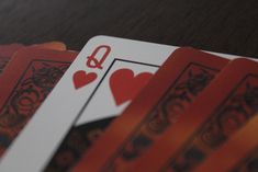 four playing cards with the letter q on them