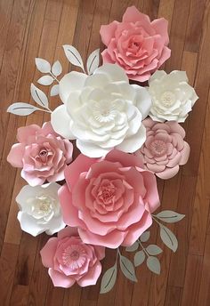 paper flowers are arranged on a wooden floor