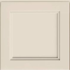 a white cabinet door with an empty square in the center and two smaller squares at the bottom