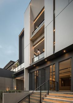 a man standing on the balcony of a modern building