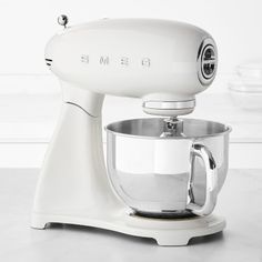 a white mixer sitting on top of a counter