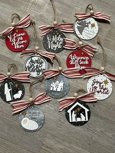 christmas ornament hanging from string on wooden floor with red and white striped ribbon