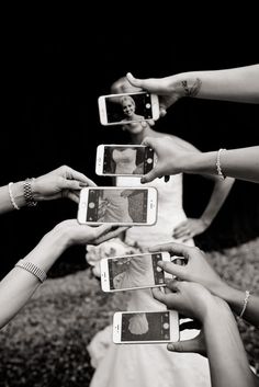 a group of people holding up their cell phones