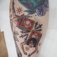 a woman's leg with tattoos on it