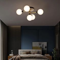 a bed room with a neatly made bed and four lights on the ceiling above it