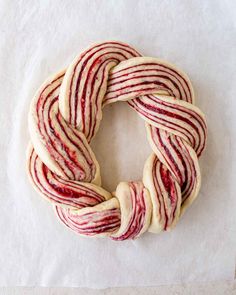 a doughnut with red and white stripes sitting on top of a piece of paper