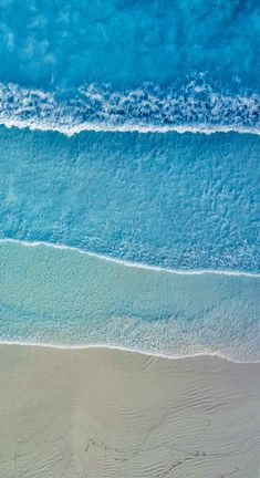 an aerial view of the ocean and beach