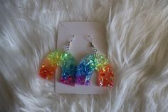 Each pair of sparkly rainbow earrings are handmade to order, therefore no two pairs are identical! However, I do my best to make them look as similar as possible :) Made with sterling silver fishhooks (clear rubber backing included), epoxy resin and rainbow flake glitter ✨  Nickel free & hypoallergenic. Perfect for LGBTQ pride, everyday wear, a gift for a friend, etc!! Thanks for visiting my shop 😊 Rainbow Nickel-free Earrings For Gifts, Nickel-free Rainbow Earrings For Gift, Nickel-free Rainbow Earrings Gift, Rainbow Hypoallergenic Earrings As Gift, Fun Rainbow Colored Earrings As Gift, Fun Rainbow Jewelry For Pierced Ears, Rainbow Fun Jewelry For Gifts, Fun Rainbow Jewelry For Gifts, Fun Rainbow Colored Jewelry For Gifts