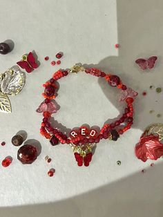 the bracelets have been made with red glass beads and gold plated metal charms