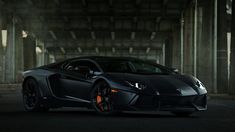 a black sports car parked in an empty parking garage