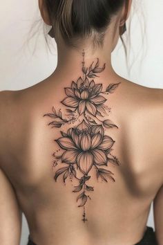 the back of a woman's neck with flowers on it