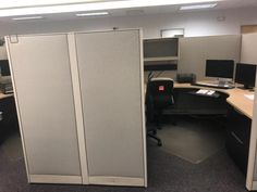 an office cubicle with two doors open