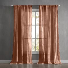 an orange curtain hanging in front of a window