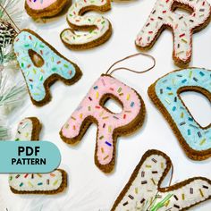 decorated cookies are arranged in the shape of letters