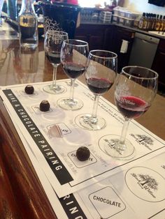 four wine glasses sitting on top of a table