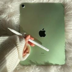 a person is holding an ipad with a pen in their hand and it's cover