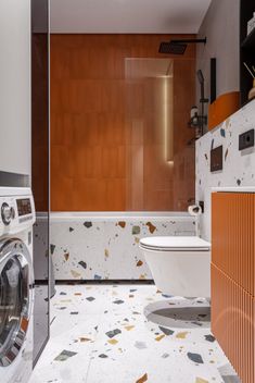 a washer and dryer in a very modern bathroom