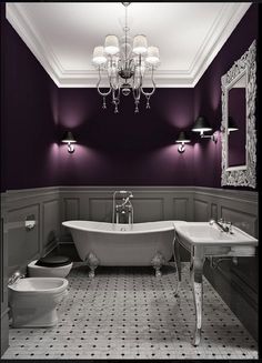 a bathroom with purple walls and white fixtures