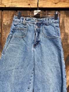 "Vintage Guess High waisted jeans.  Made in USA. Sz 27. Light acid wash. Back pocket has small hole. 2 buttons and zipper closure. Waist-12\" length-37\"" Light Wash Straight Leg Jeans With Button Zip Fly, Vintage High-waist Denim Cargo Jeans, Vintage High Waist Denim Cargo Jeans, Medium Wash High Rise Jeans With Button Closure, High Rise Washed Blue Jeans With Button Closure, High Rise Jeans With Button Closure In Medium Wash, Light Wash Jeans With Button Closure, High Rise Light Wash Jeans With Button Zip Fly, High Rise Denim Cargo Jeans With Button Closure