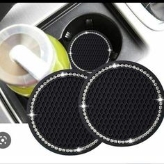 two black car mats sitting on top of a stove next to a cup and saucer