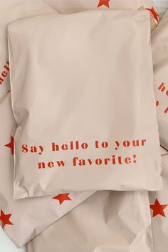 four pillows with red stars on them that say, say hello to your new favorite