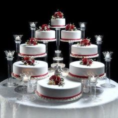 a table topped with lots of white and red cakes